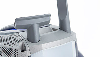 Convenient slots on the vacuum cleaner body for upholstery and crevice nozzles