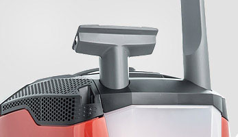 Convenient slots on the vacuum cleaner body for upholstery and crevice nozzles