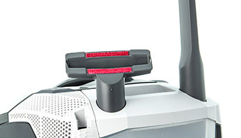 Convenient slots on the vacuum cleaner body for upholstery and crevice nozzles